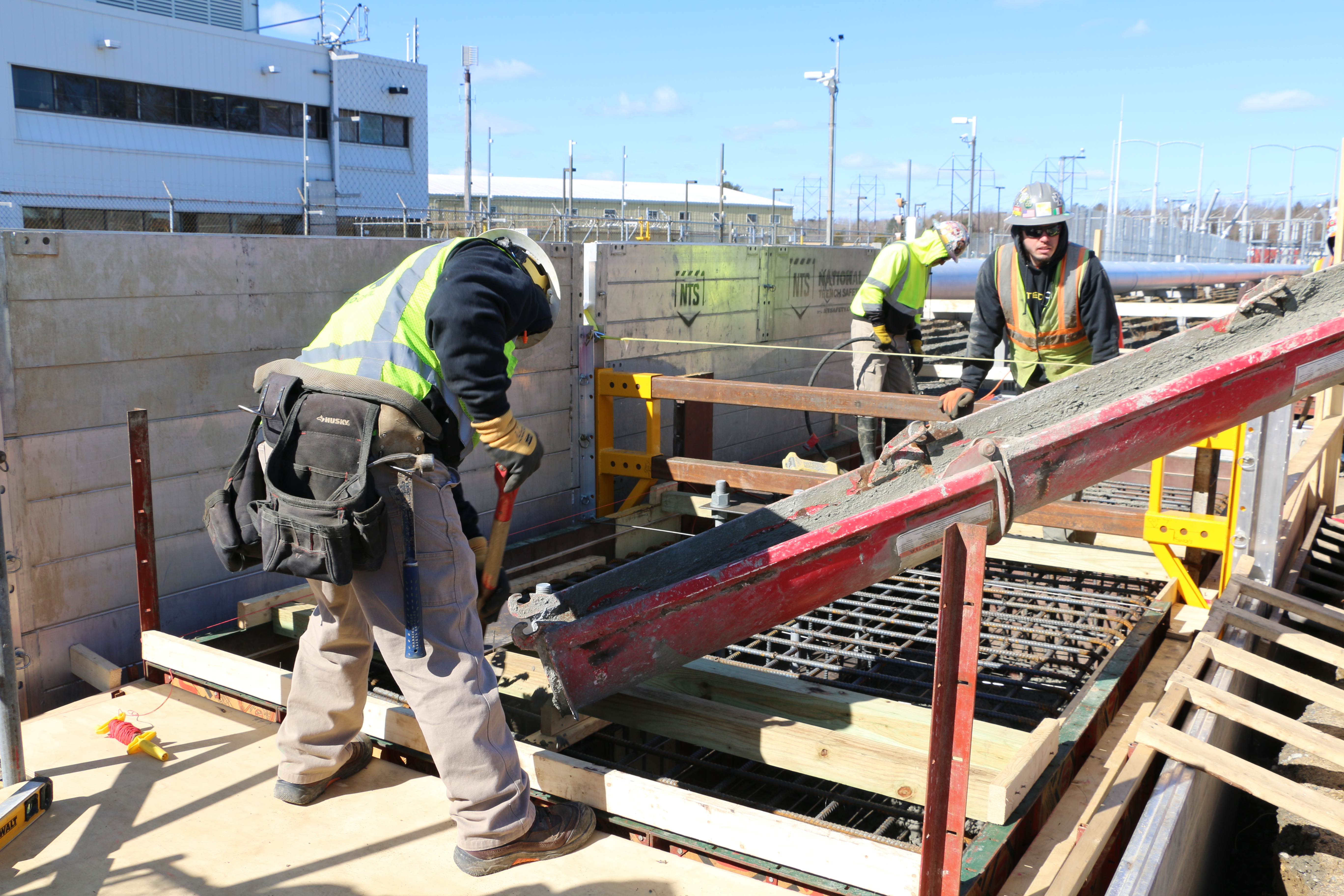 United Civil workers placing cast-in-place concrete foundations inside an active energy facility construction site