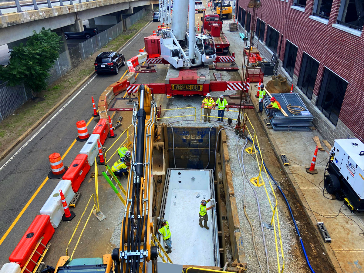 Aerial view of United Civil crews performing multi-lane ductbank installation in a densely built urban street corridor