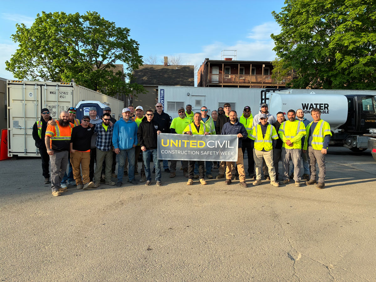 United Civil crew holding up a Construction Safety Week banner